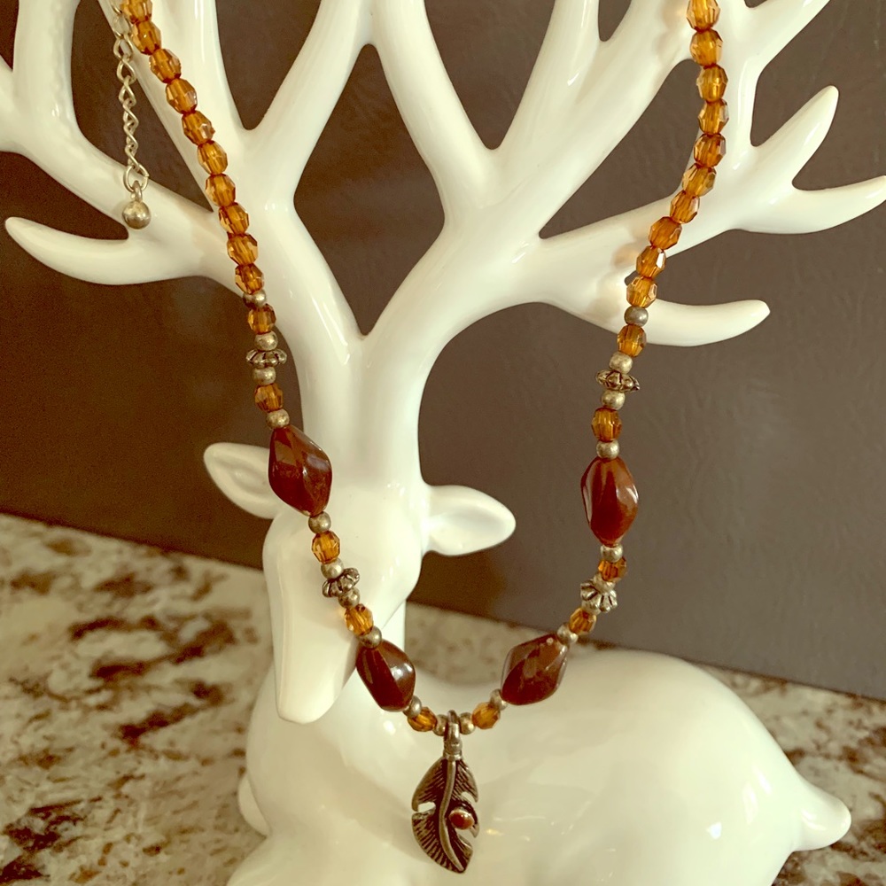Brown beaded necklace w/ silver-tone feather